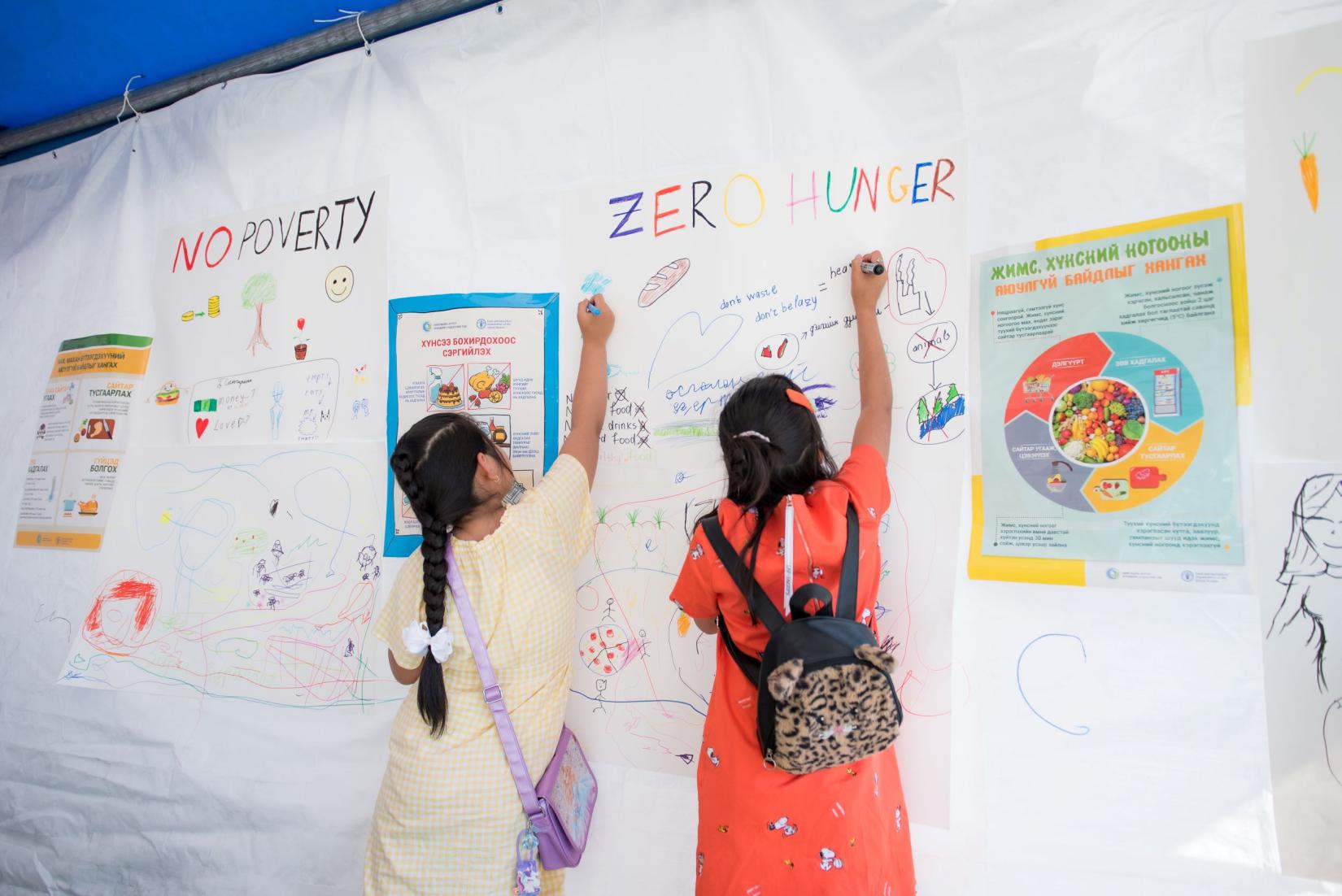 kids at the SDG OPen day - writing on wall