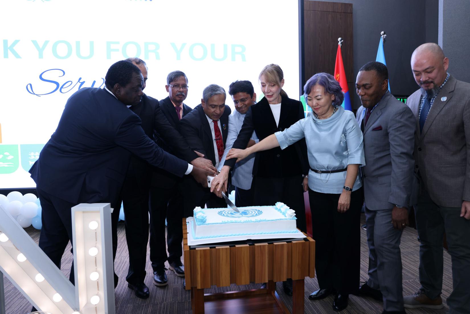 UNCT members cutting a cake